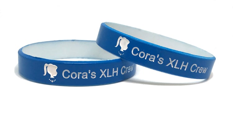 Two blue color coat wristbands with personal messages.